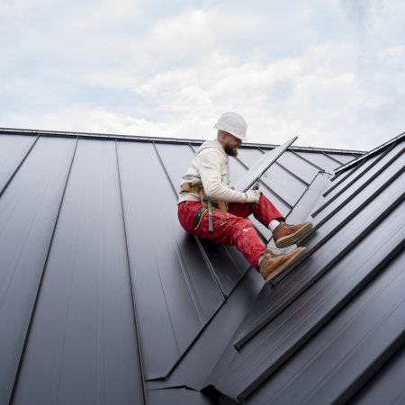 full-shot-man-with-helmet-sitting-roof-scaled-1.jpg