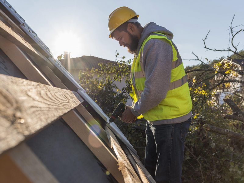 man-working-roof-with-drill-1-scaled-1.jpg